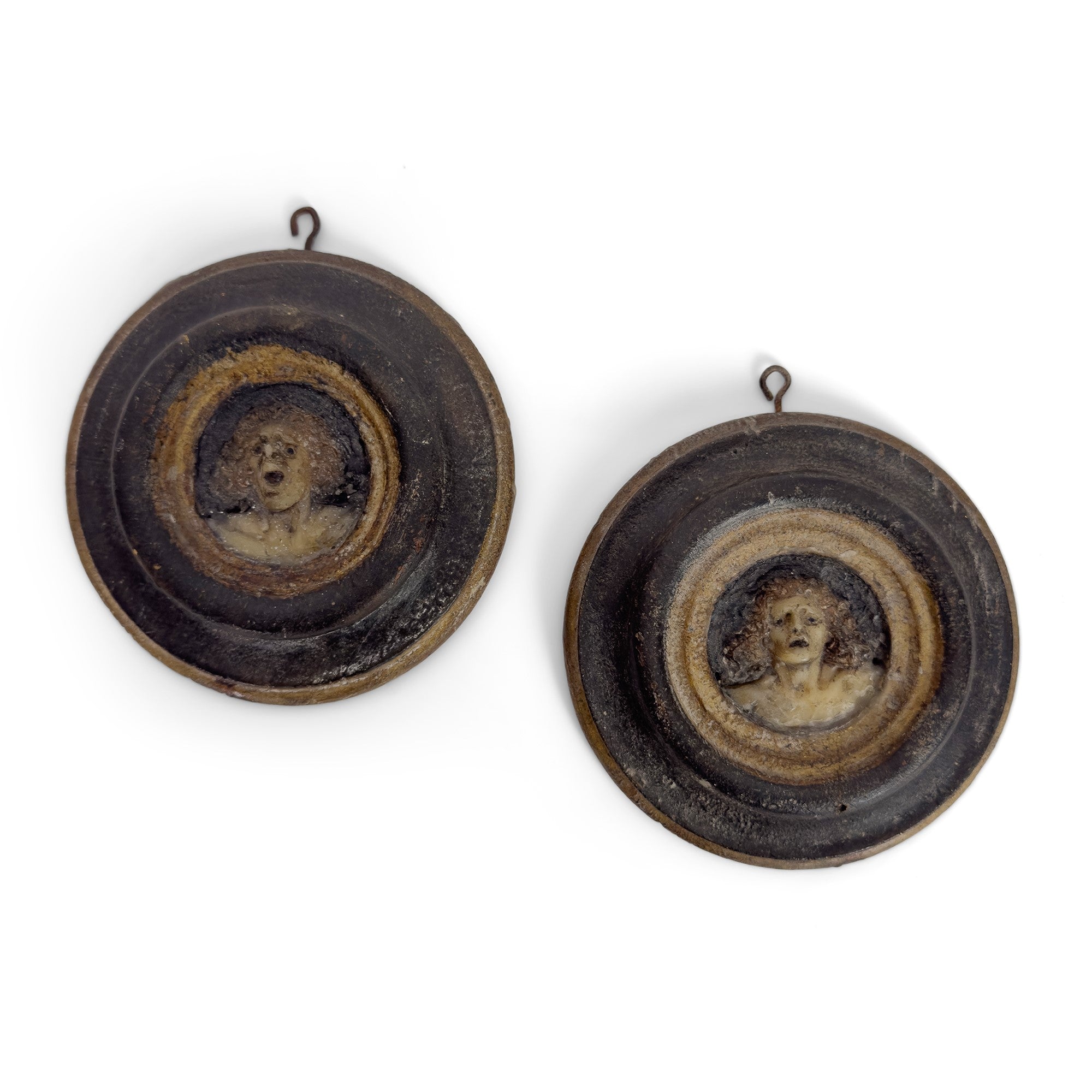 Pair of antique 18th century Italian polychrome wax roundels depicting damned souls curated by Le Historique