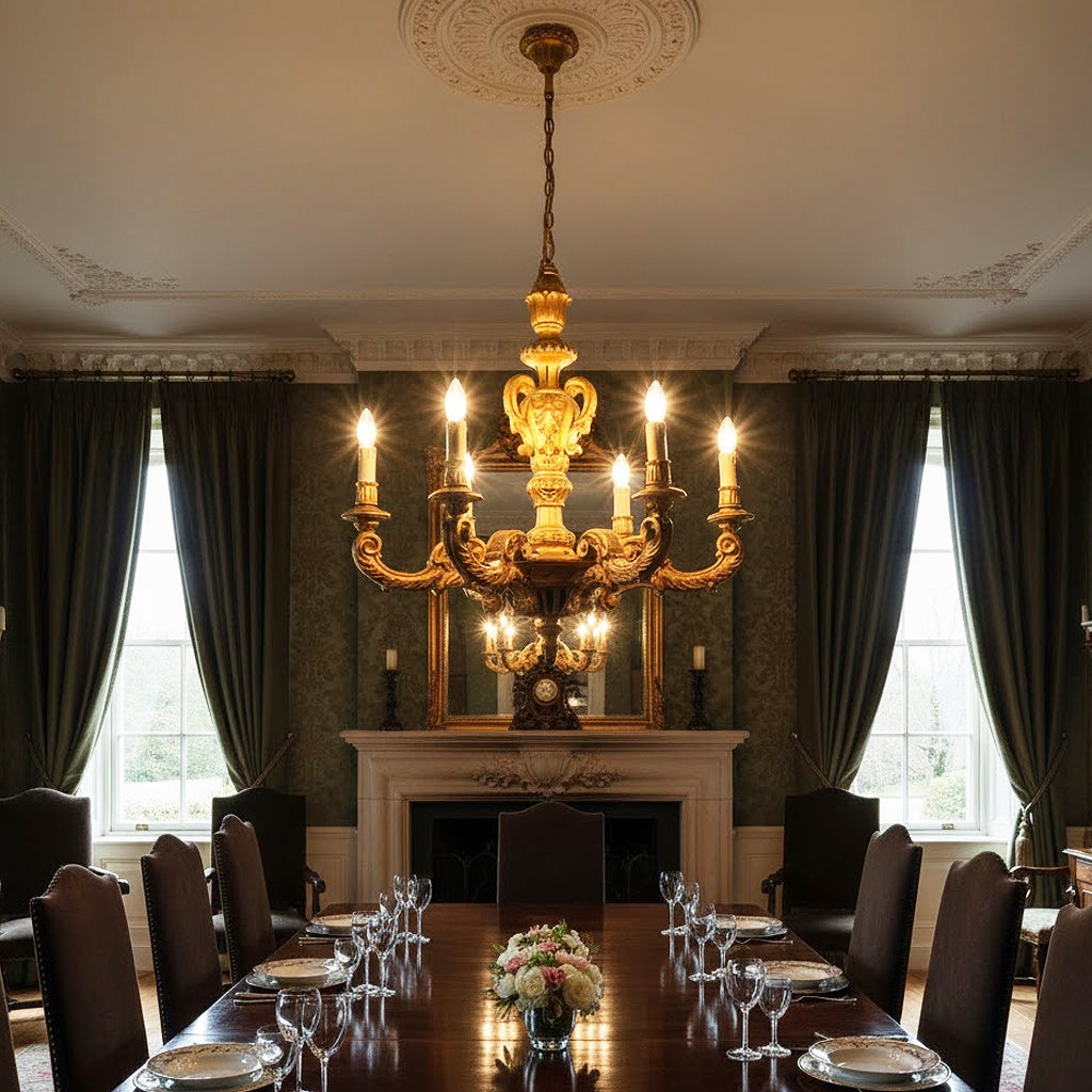 Dining room with a large ornate 19th-Century Hand-Carved Giltwood chandelier, table set for dinner, and fireplace.