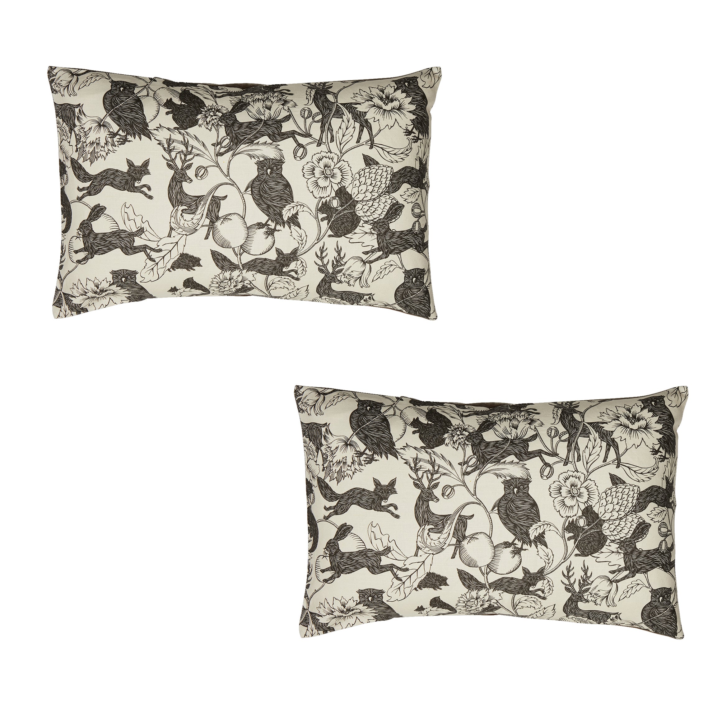 Two decorative pillows with black and white animal pattern on a white background
