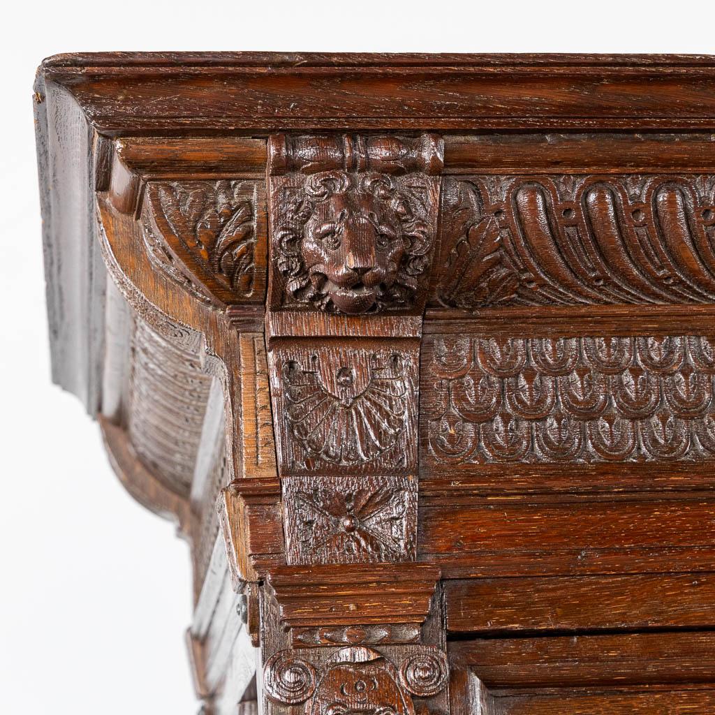 High-relief lion mask carvings on antique Flemish oak furniture highlighting 17th century craftsmanship