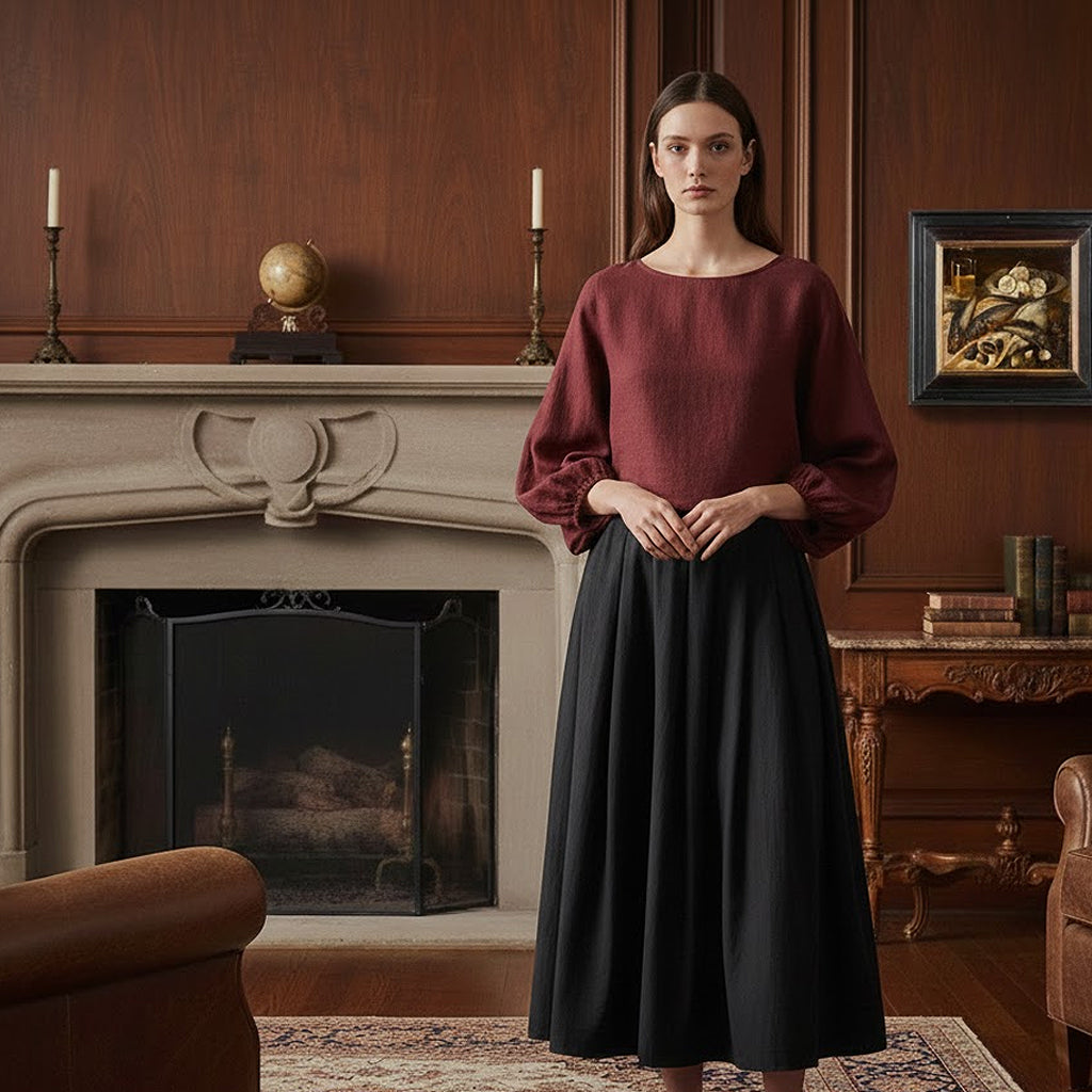 Elegant Bordeaux linen cropped top paired with a black pleated midi skirt, showcasing a preppy heritage-inspired look in a wood-paneled study.