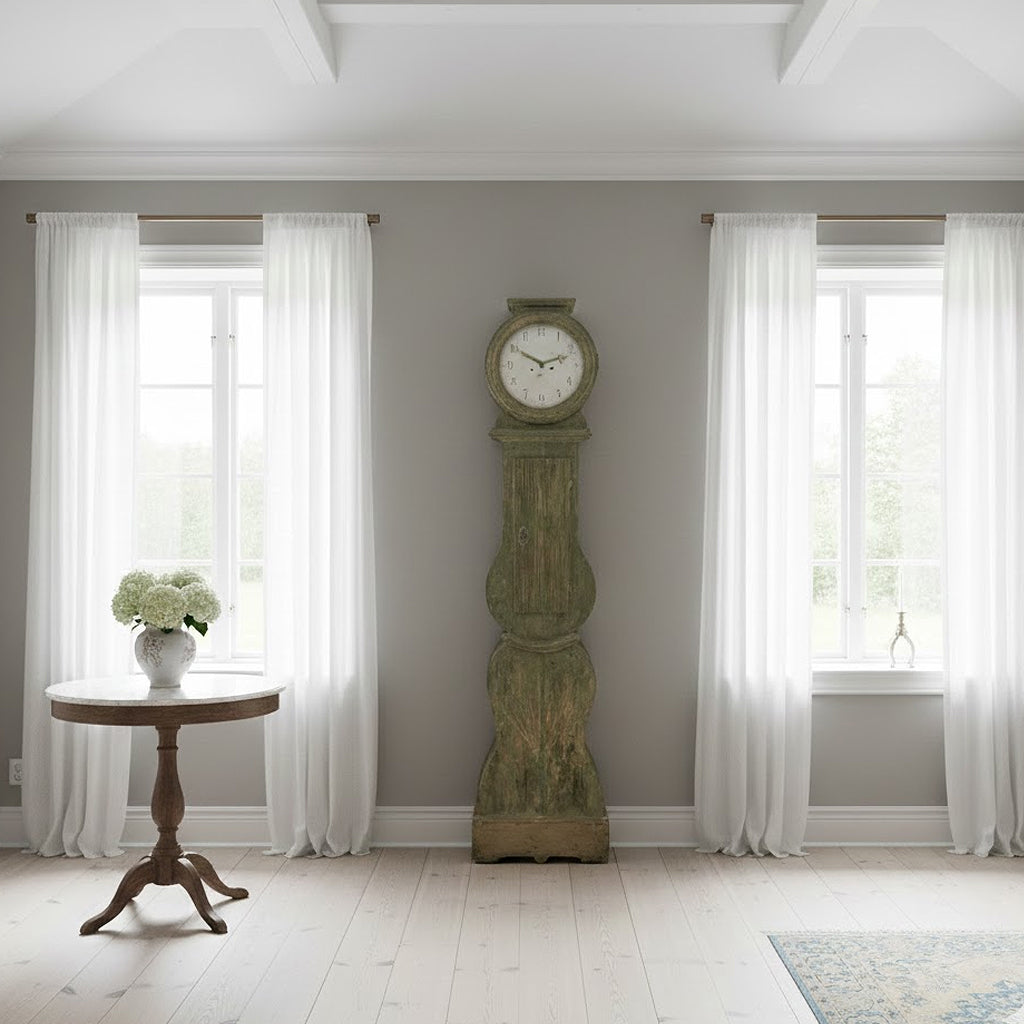 Mid-19th century Swedish Mora clock in aged sage-gray curated by Le Historique set in a modest Gustavian interior