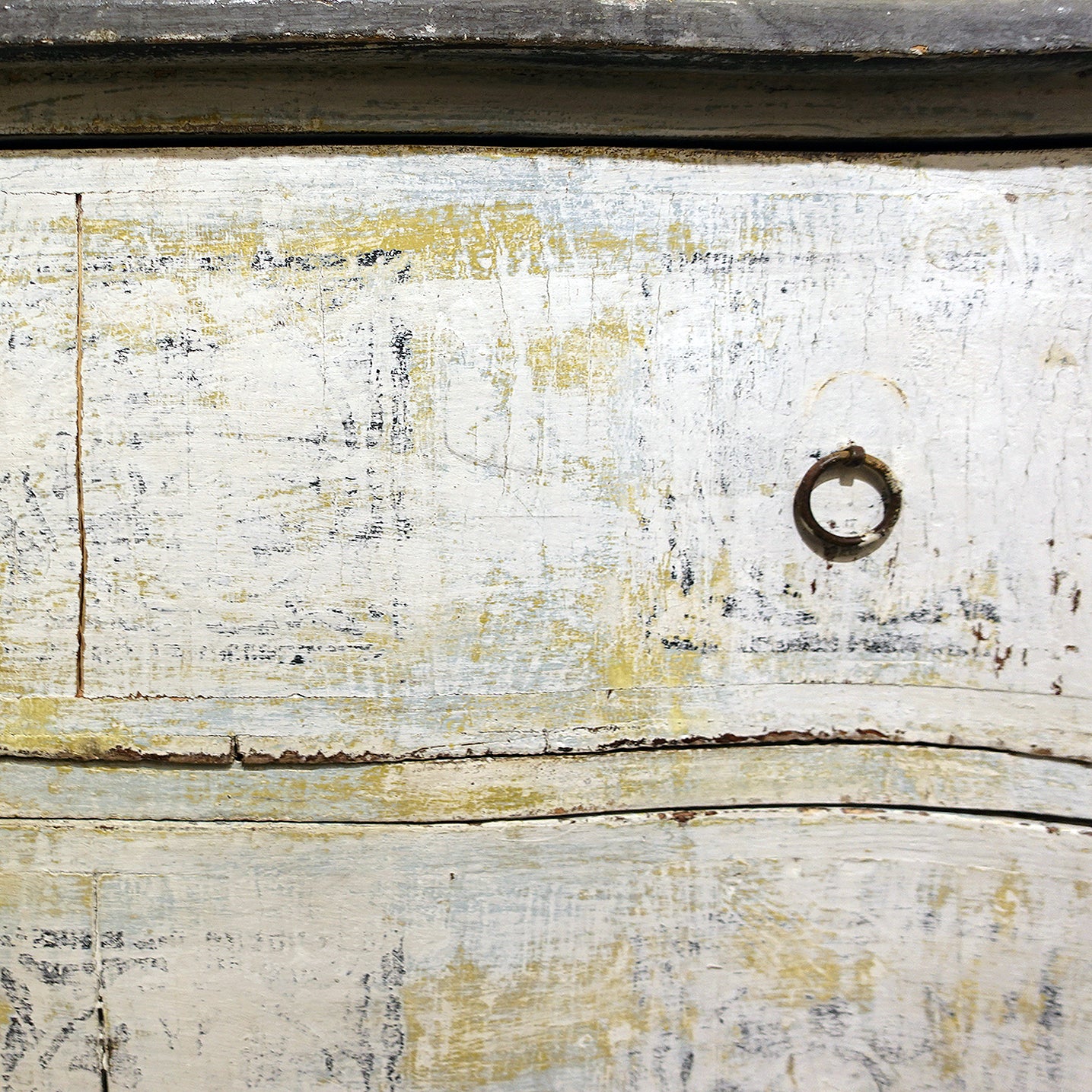 Original iron ring pulls and faded stencil detail on antique Florentine cabinet drawers