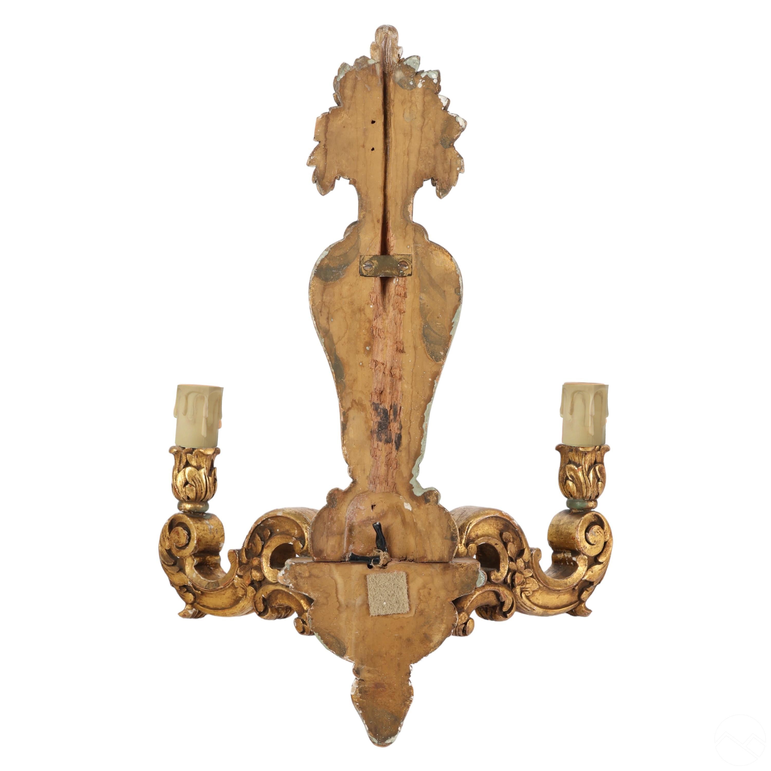 Decorative wall sconce with intricate carvings on a white background