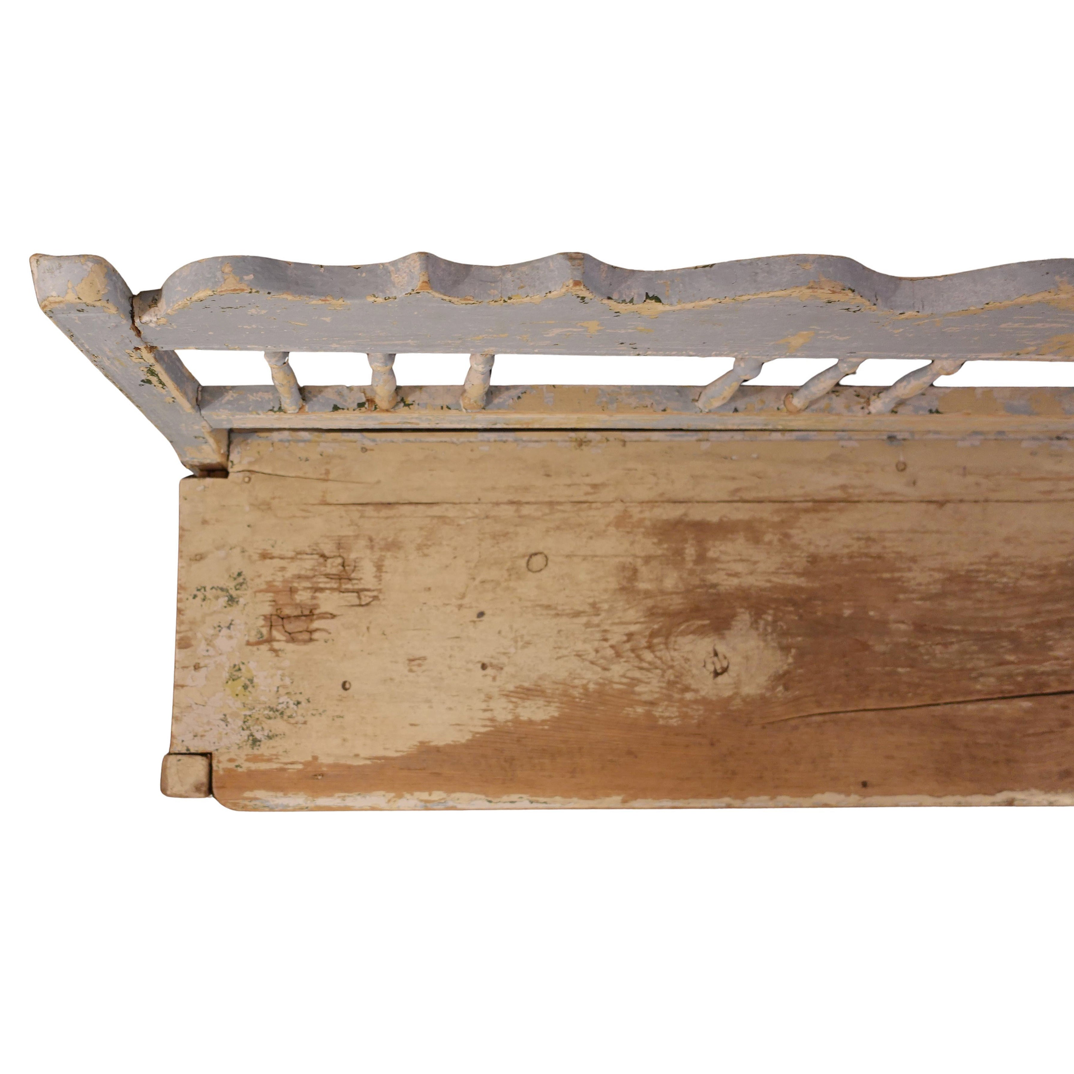Detail of the hand-scraped wooden seat and scalloped backrest of a Swedish antique bench, showcasing the layered elegance of Gustavian craftsmanship.