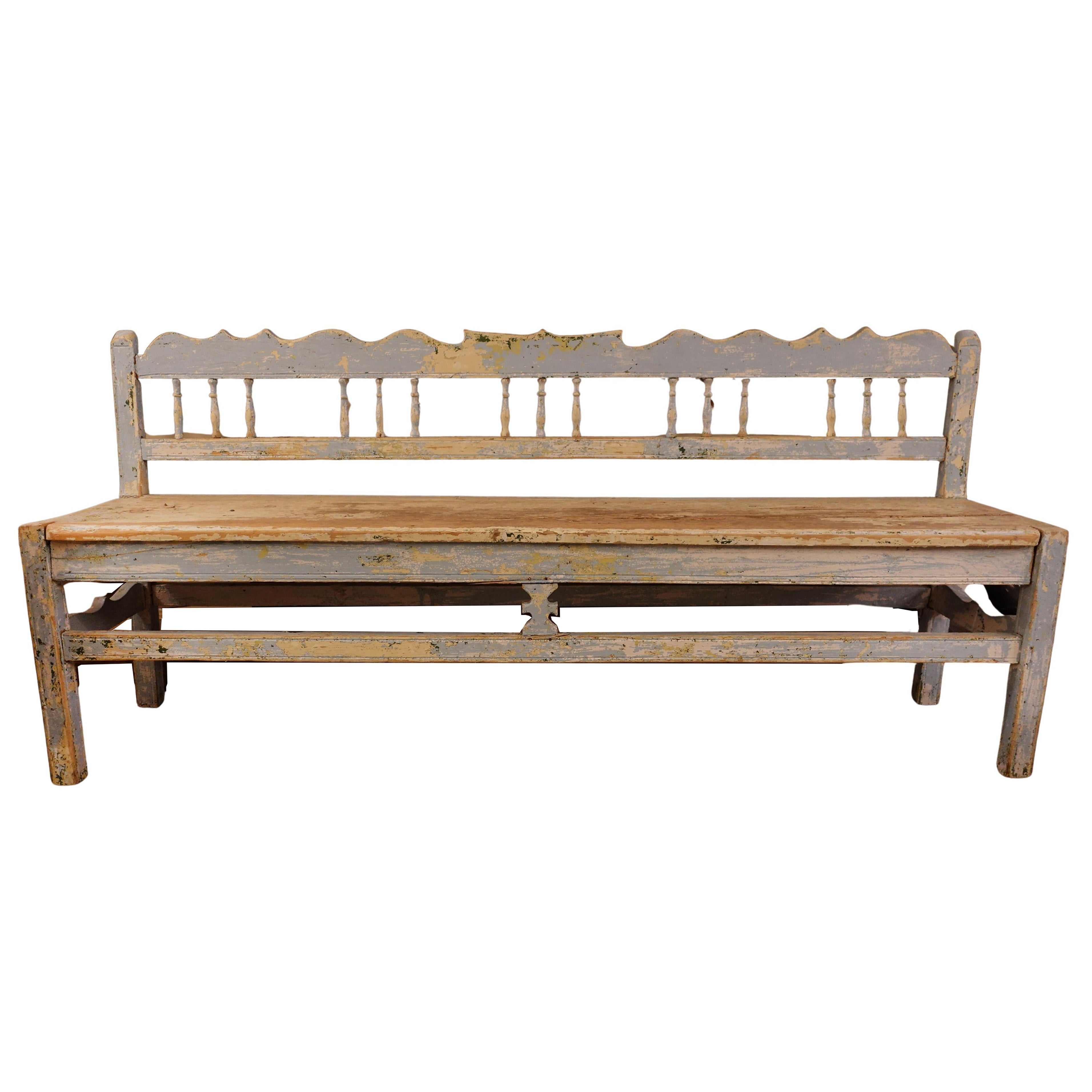 19th-century Swedish Gustavian bench with original blue-grey distressed paint, hand-carved spindles, and Neoclassical silhouette for high-end interior design.