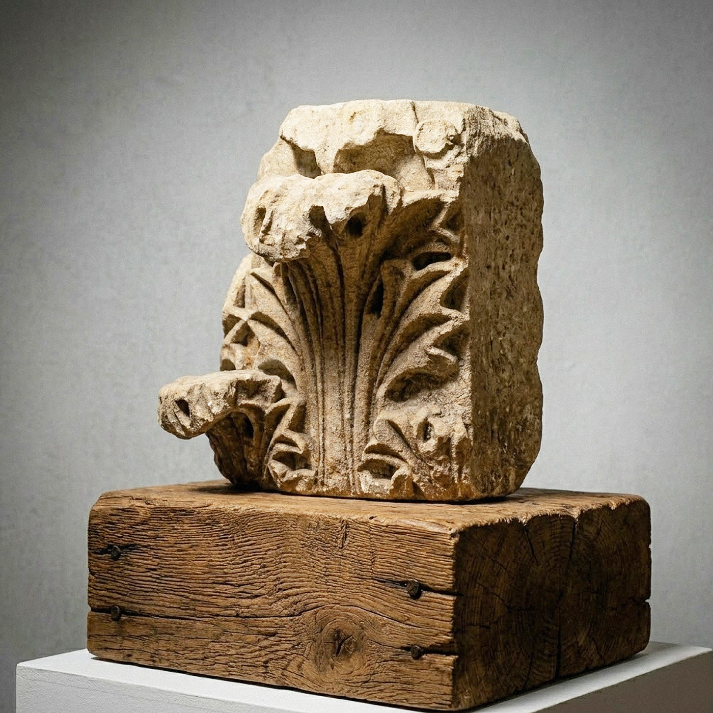 Side profile of antique Gothic Rayonnant style carved stone capital showing deep undercutting