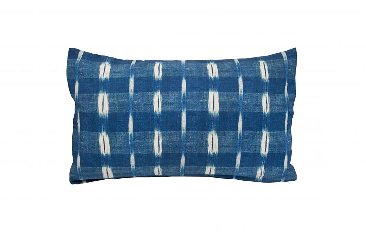 Blue and white patterned pillow on a white background