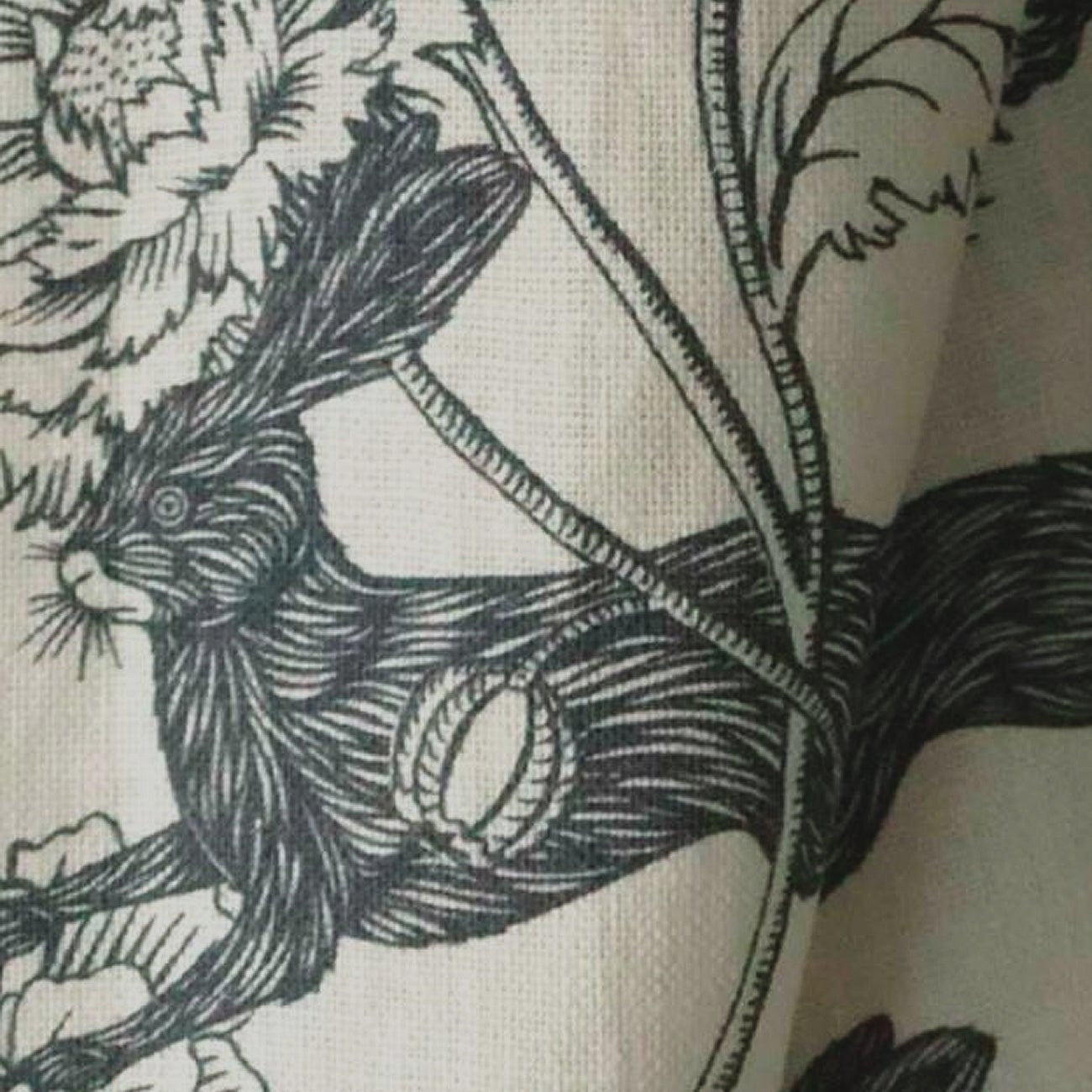 Black and white floral and rabbit design on fabric