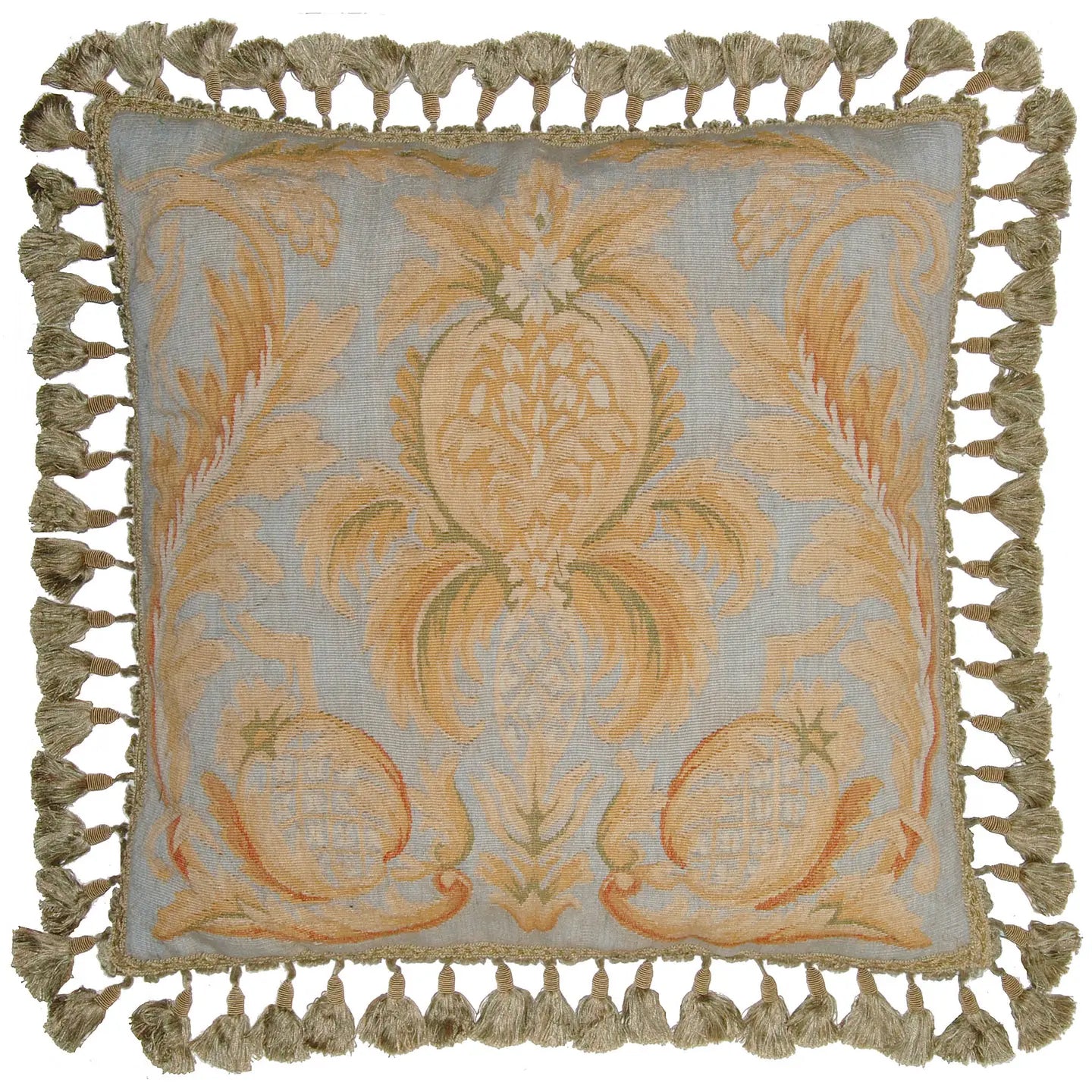 Decorative pillow with intricate floral pattern and tassels on a light blue background