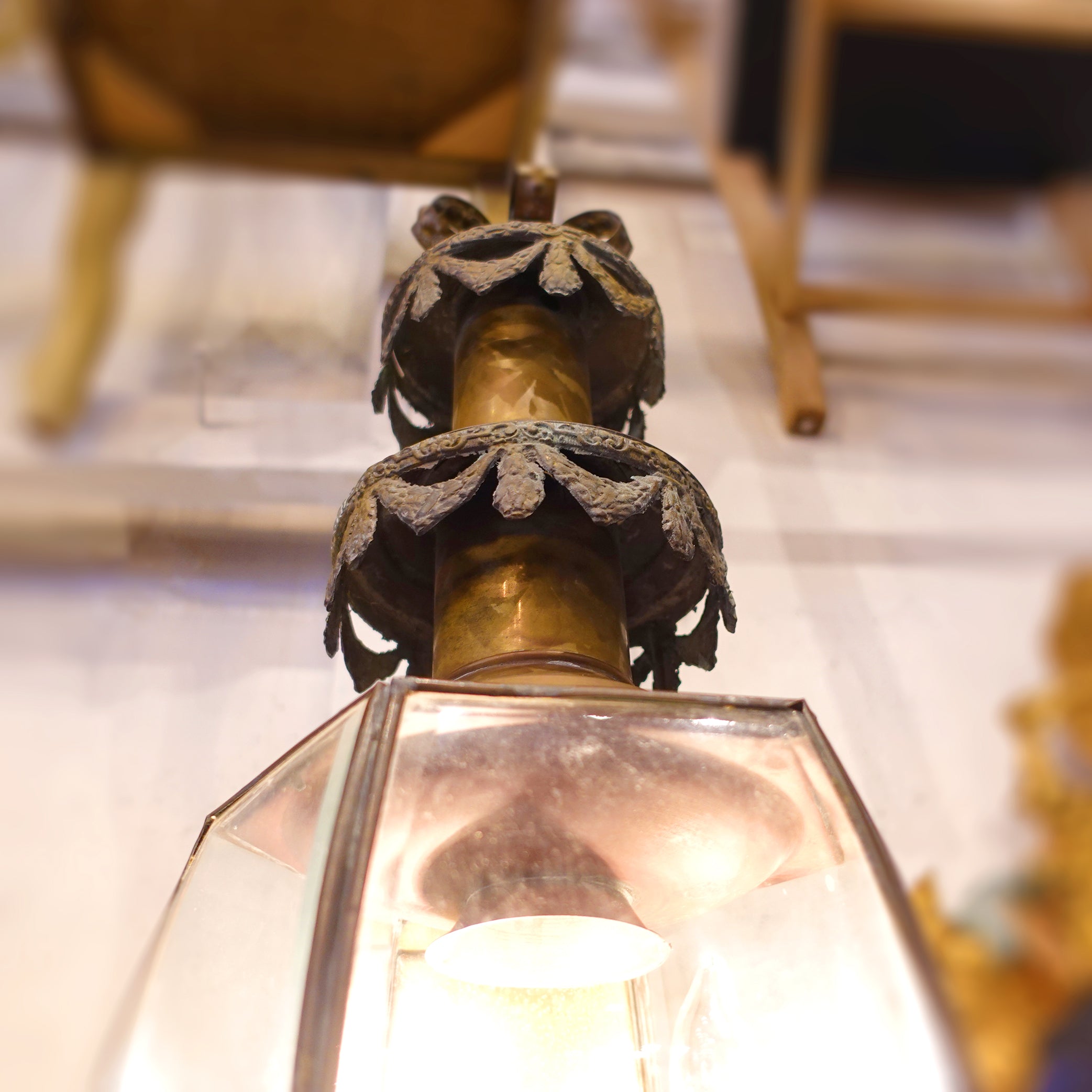 Close-up detail of a funerary carriage lantern with copper swag decor.