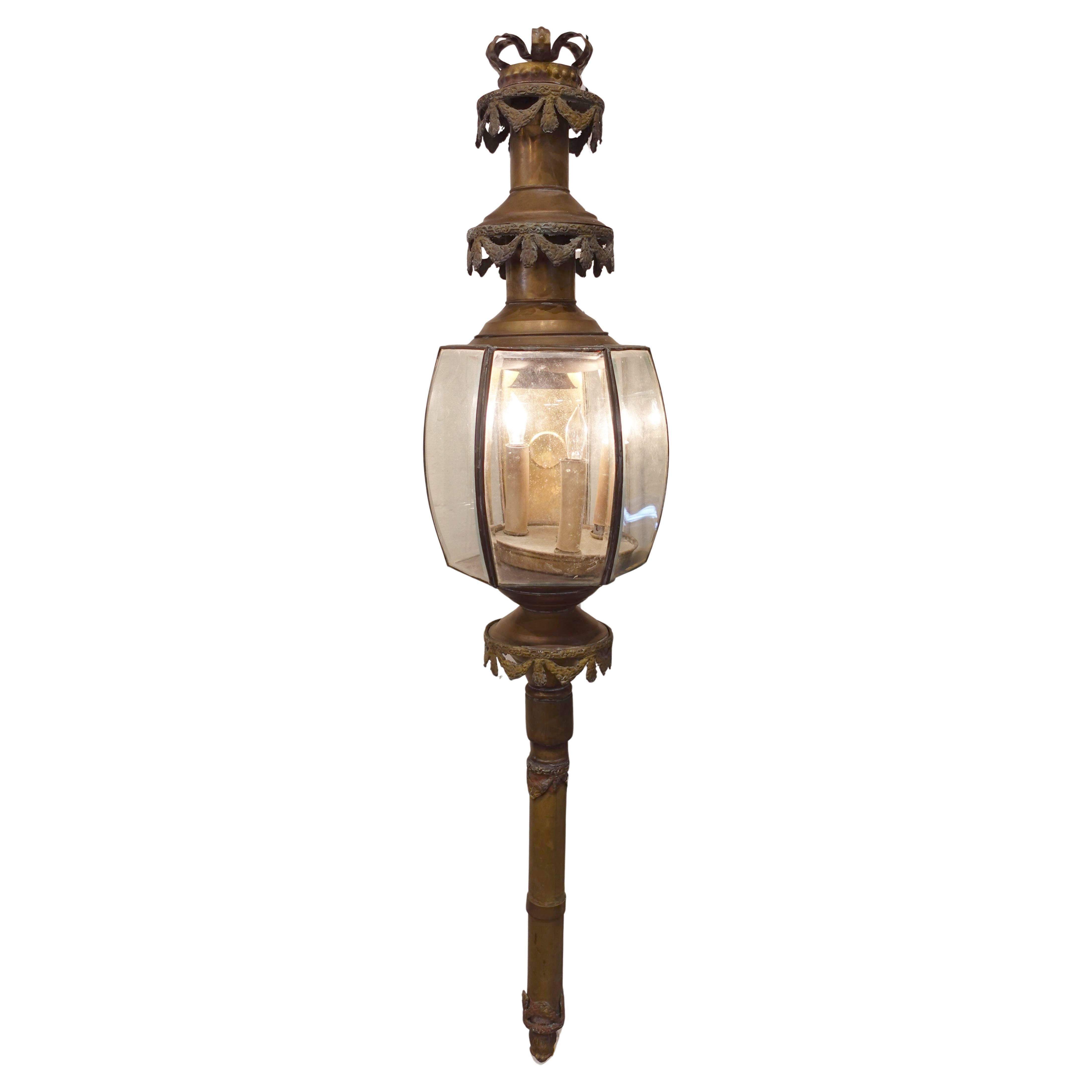 Decorative antique outdoor funerary carriage lamp with glass shade on a white background