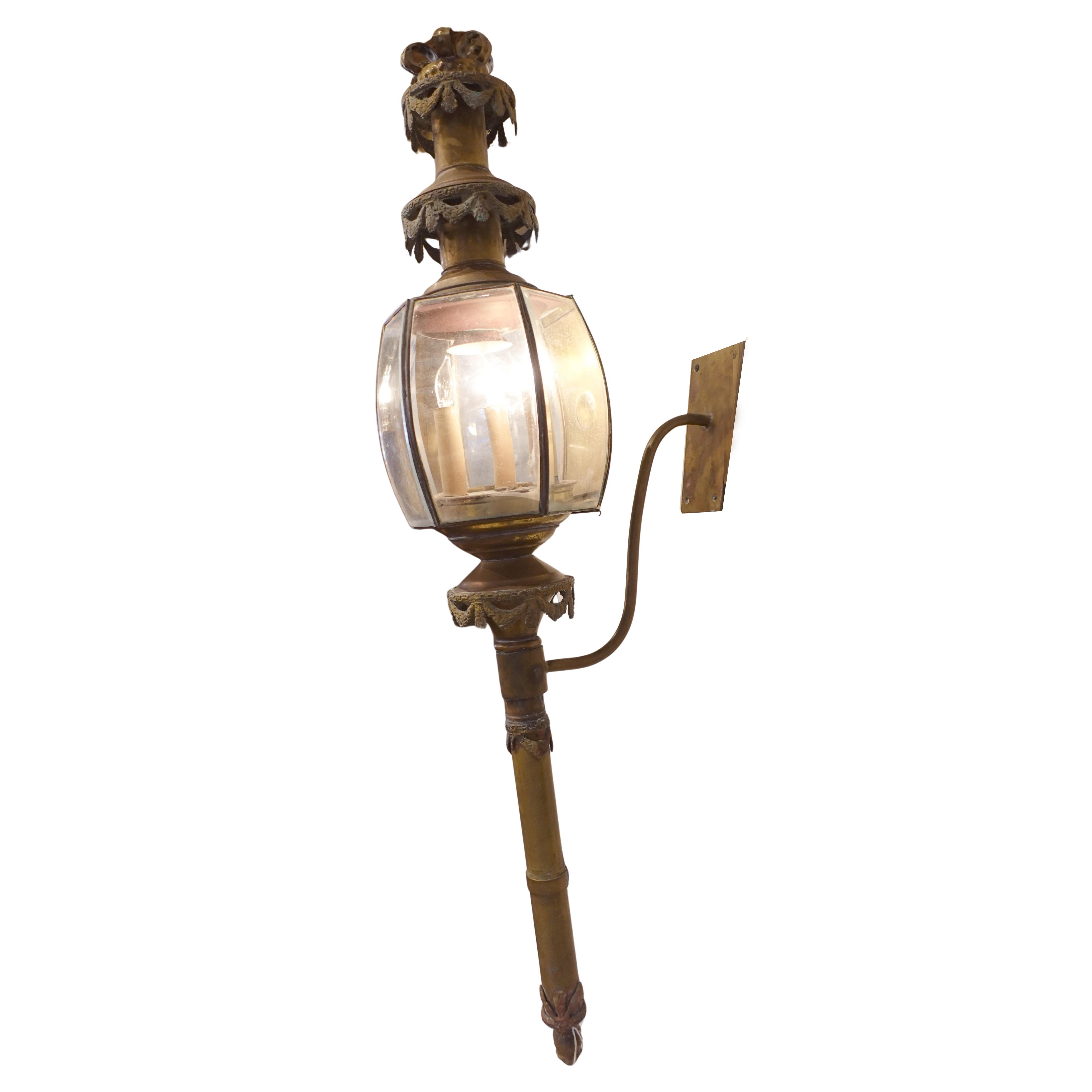 Decorative antique wall light funerary carriage fixture with glass shade on a white background