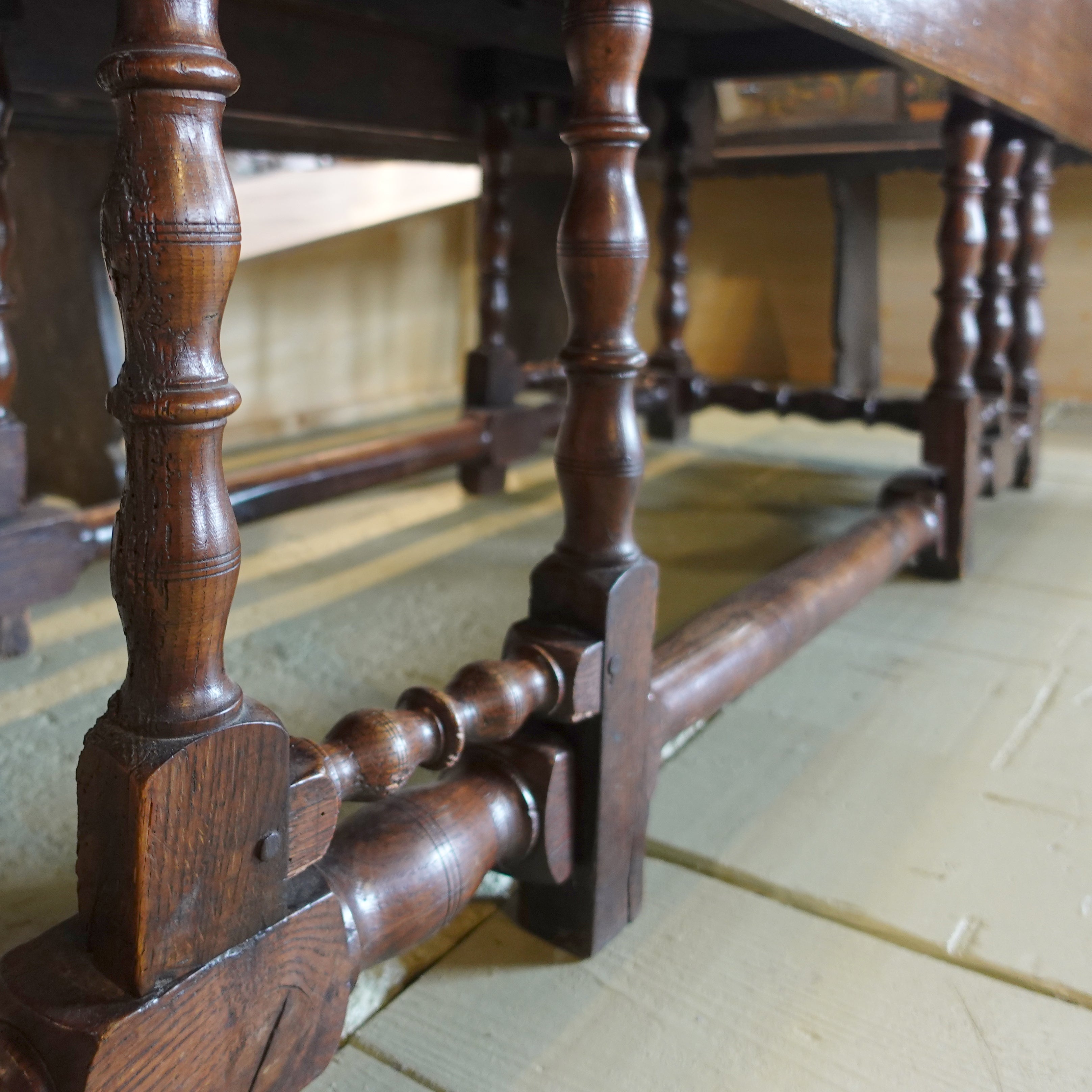 detailed close up of the legs of an Antique early 1800s English oak drop-leaf gateleg table