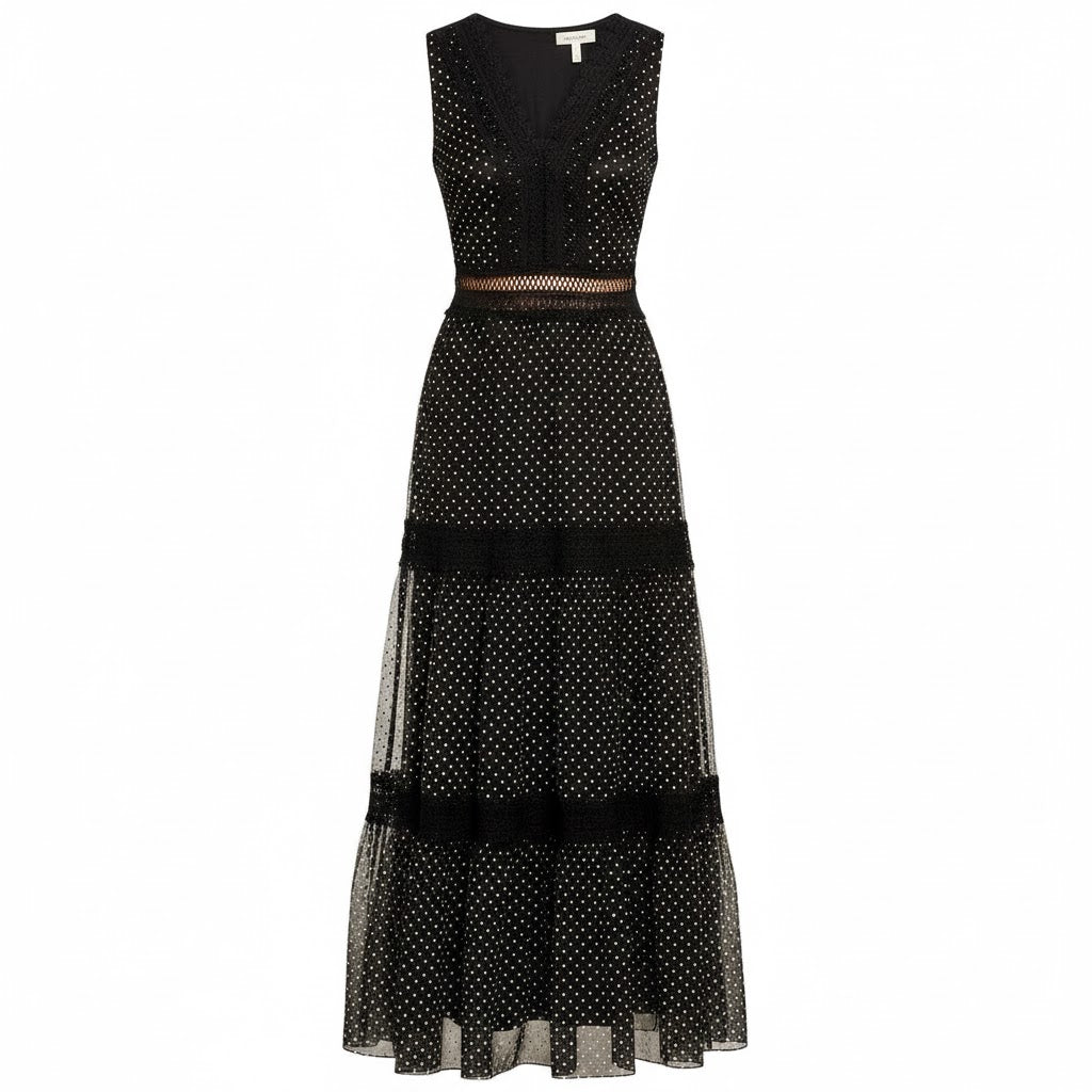 Black polka dot dress with sheer overlay on a white background