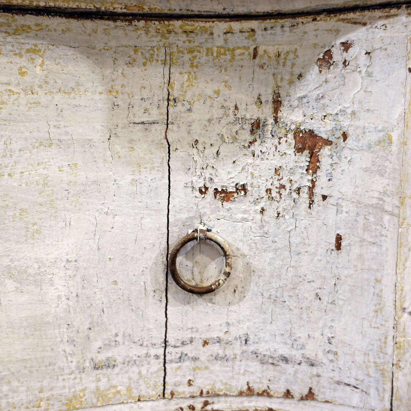 Original iron ring pulls and faded stencil detail on antique Florentine cabinet drawers