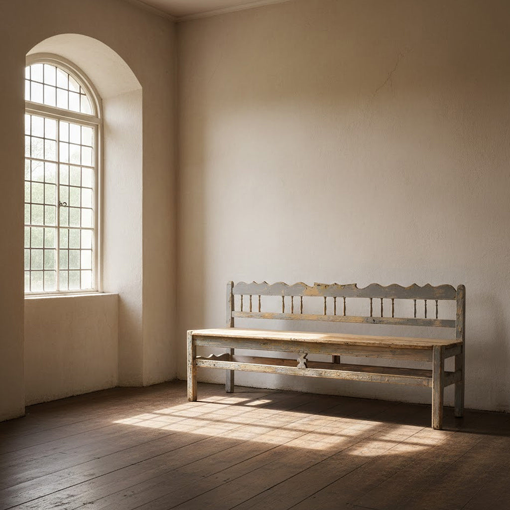 19th century Swedish Gustavian bench in an empty room with natural window light