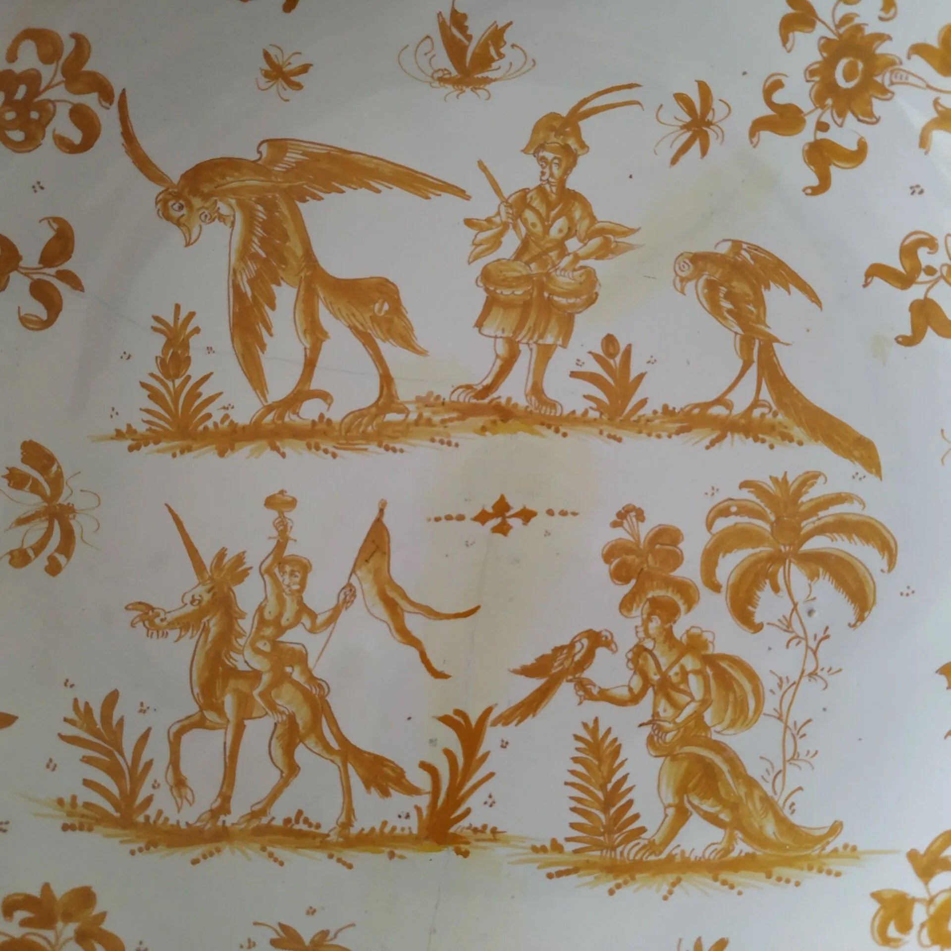 Detail rare 18th-century French Moustiers Faience earthenware deep plate featuring yellow monochrome ochre grotesque decoration in the style of Jacques Callot, curated by Le Historique.background