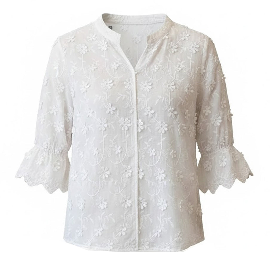 Well-constructed white cotton-blend blouse with artisanal flower embroidery and a minimalist button-front design on a clean white background.